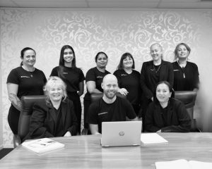 A black and white photo of the business like chartered accountants team sitting in their boardroom