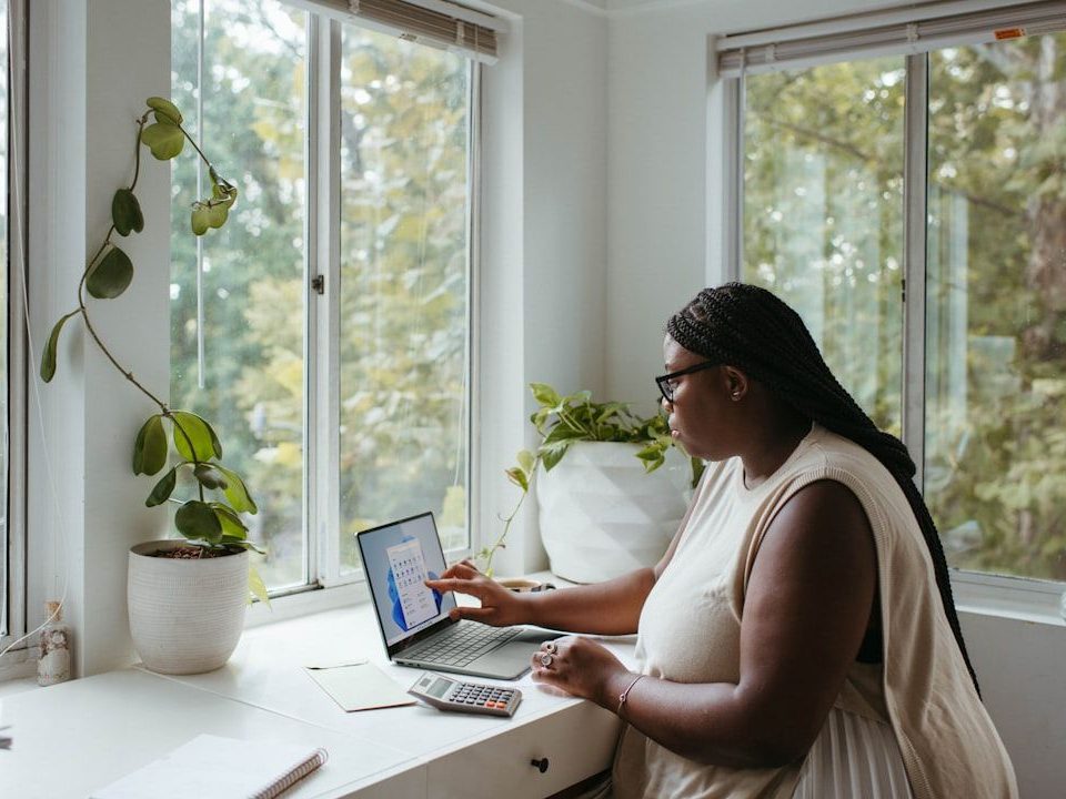 Lady working from her home office which she can claim a portion of costs for tax purposes